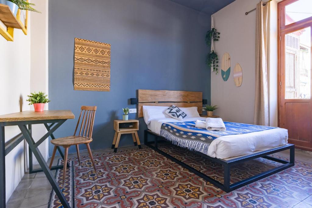 een slaapkamer met een bed en een tafel en stoelen bij Bird House in Valencia