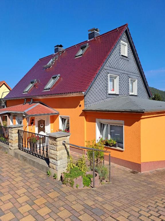 a large orange house with a red roof at Feriendomizil Elbsandsteingebirge in Königstein an der Elbe