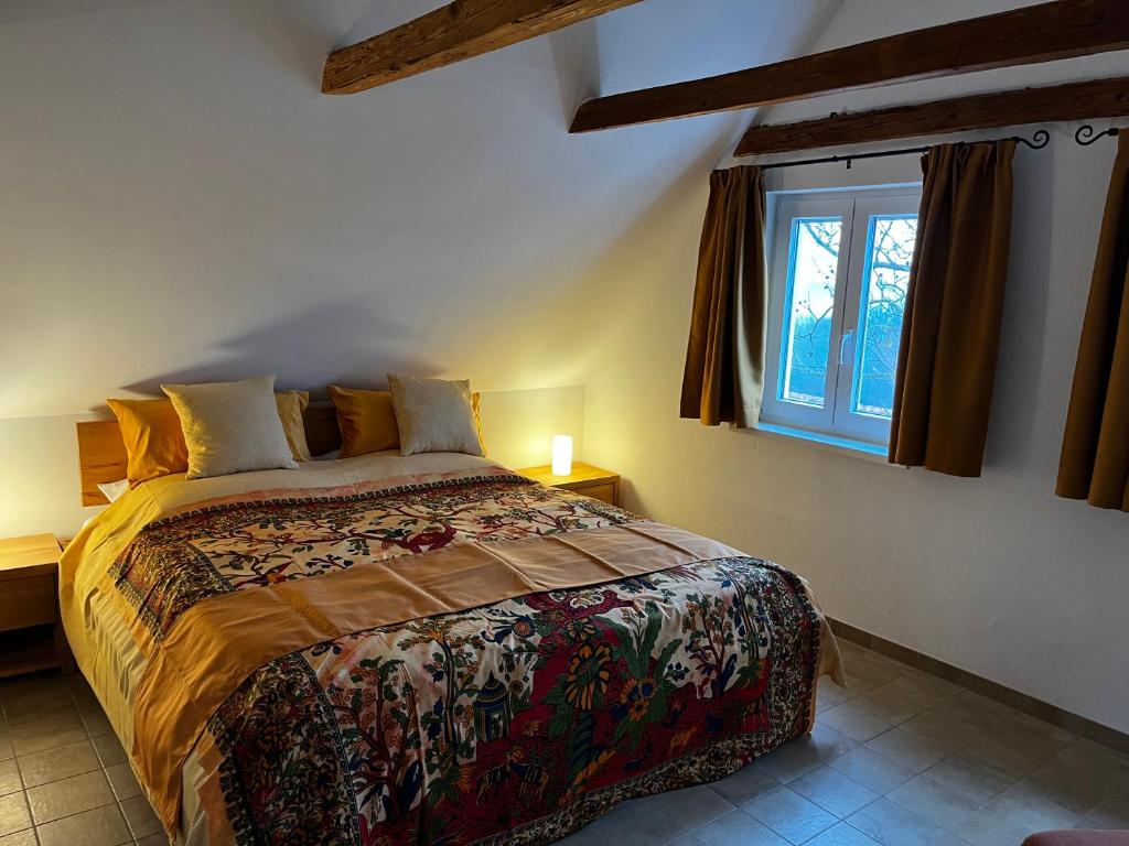 a bedroom with a large bed with a window at Ferienhaus Thonjoergl in Gnas