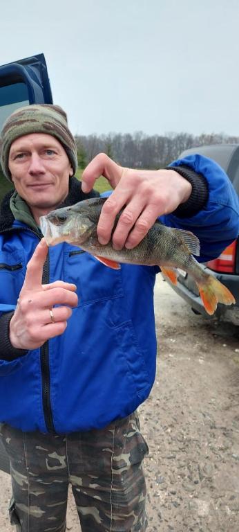 a man holding a fish in his hands at Family Resort in Mostiska