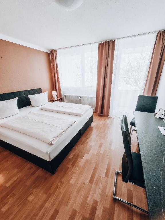 a hotel room with a bed and a desk and a desk at Zentral Hotel in Bad Füssing