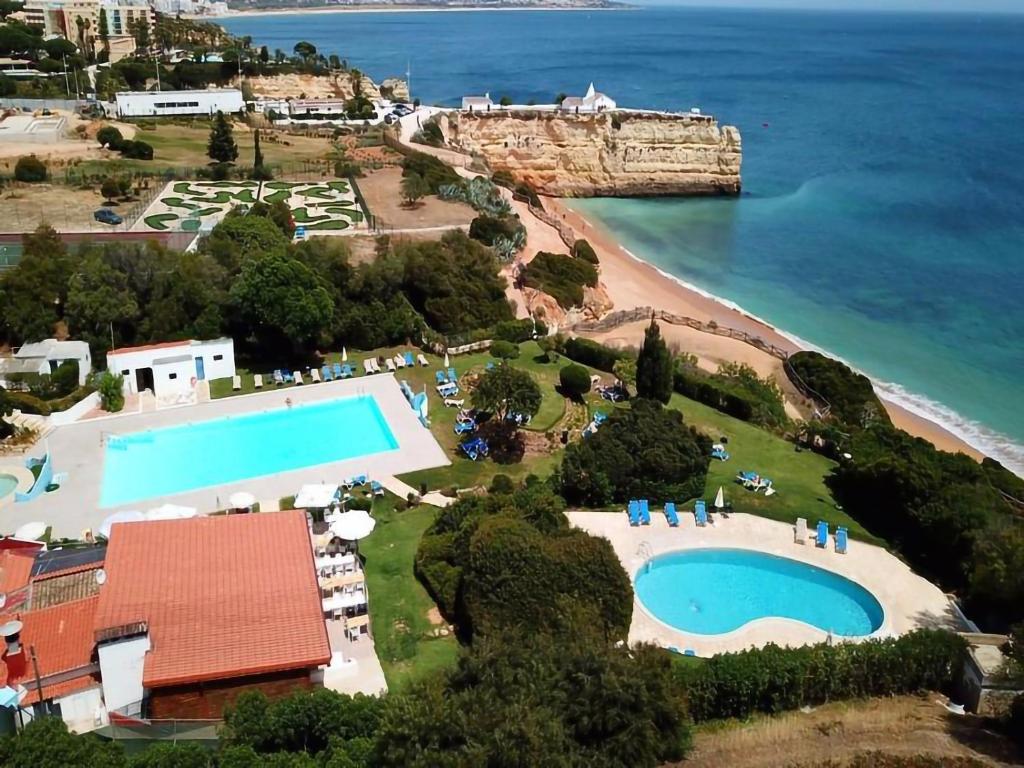 an aerial view of a resort with a swimming pool and a beach at Casa da Rocha in Armação de Pêra