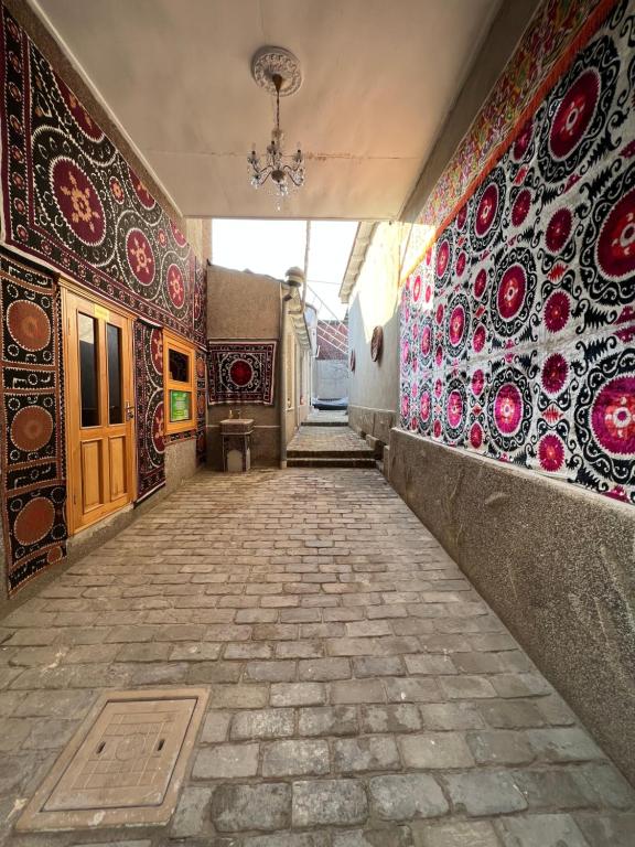 an empty hallway with colorful tiles on the walls at AL-MOTRUDIY in Samarkand