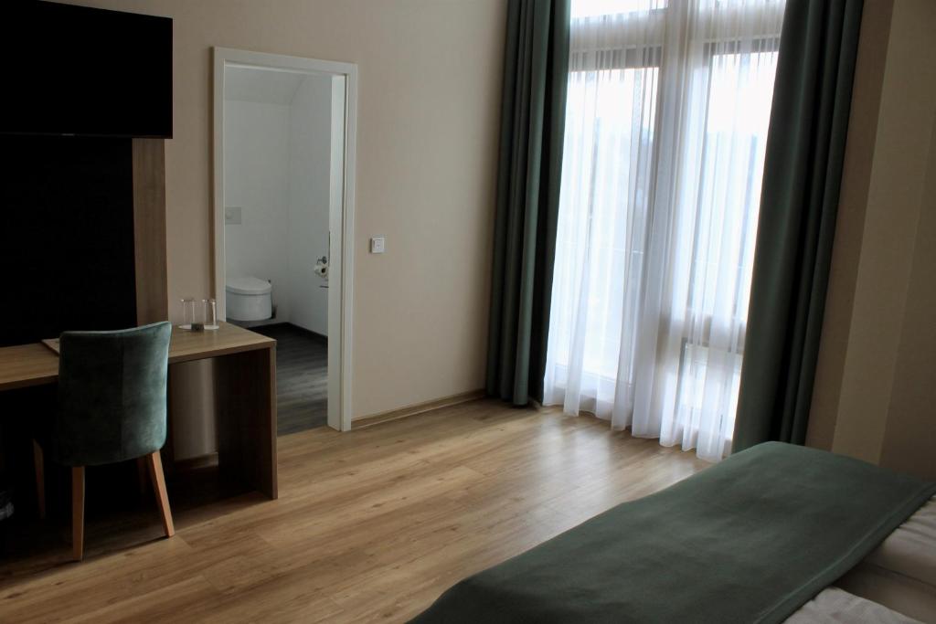 Postel nebo postele na pokoji v ubytování Troll's Brauhaushotel