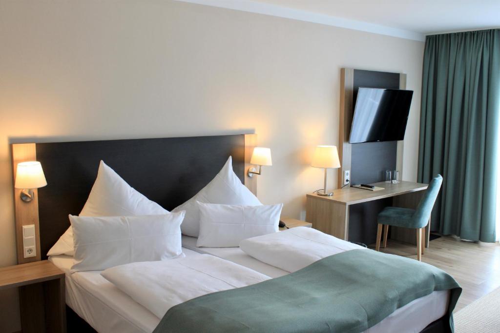 Postel nebo postele na pokoji v ubytování Troll's Brauhaushotel
