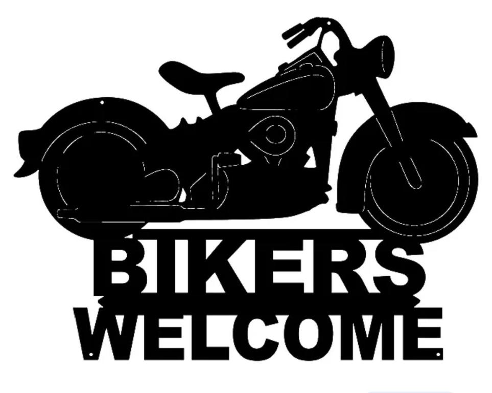 a motorcycle parked next to a sign that reads bikes welcome at Locanda San Martino in Massac