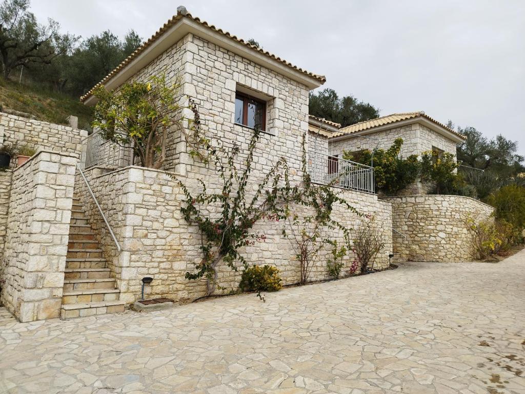 a brick building with a window and a stone wall at Mary's Panorama Houses in Gialova