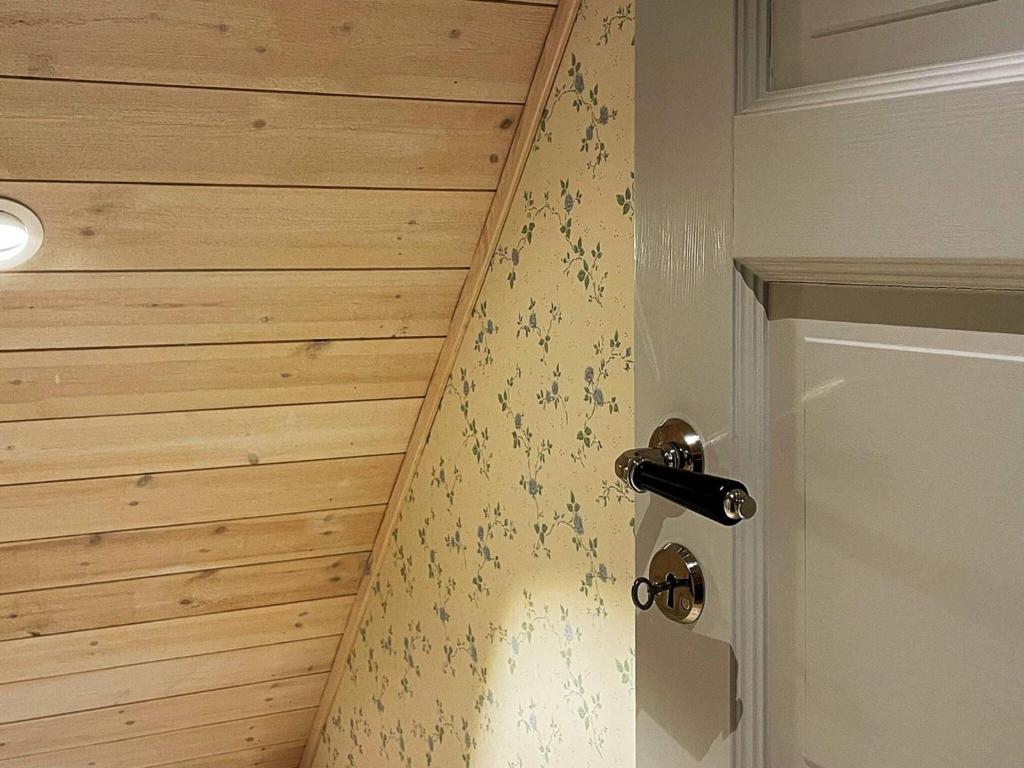 a room with a door with a wooden wall at Holiday home Löderup V in Löderup