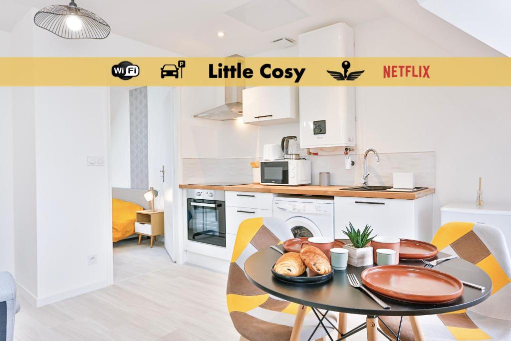 a kitchen with a table with a plate of food on it at Little Cosy - T2 avec parking in Vierzon