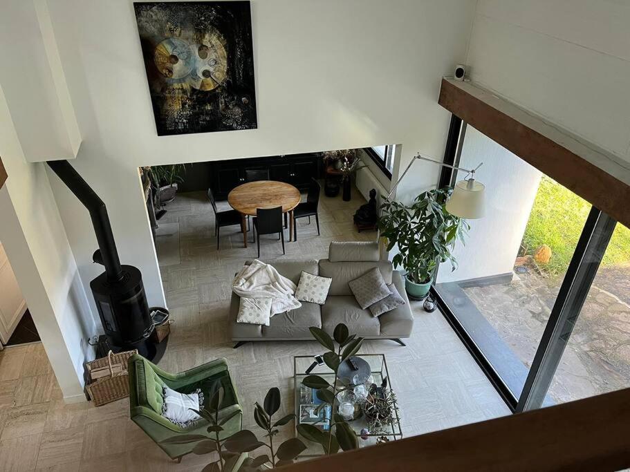 an overhead view of a living room with a couch and a table at Villa d'architecte in La Celle-Saint-Cloud