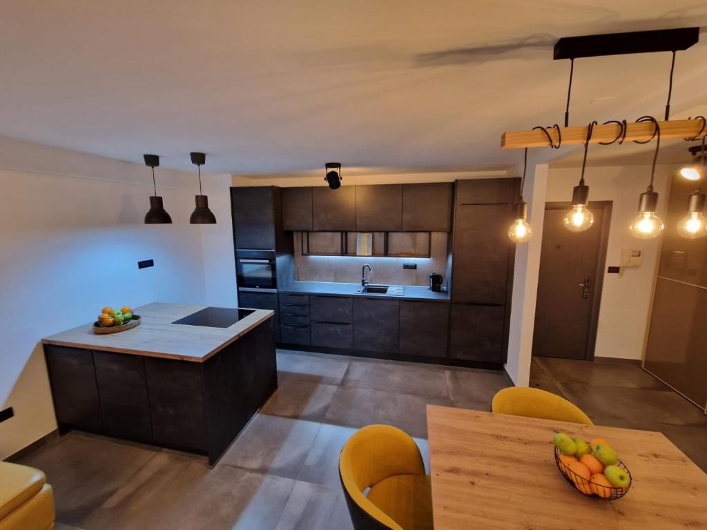 a kitchen with wooden cabinets and a table and chairs at Apartment Matea in Pula