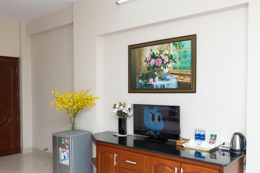 TV a/nebo společenská místnost v ubytování Queen Garden Hotel & Apartment