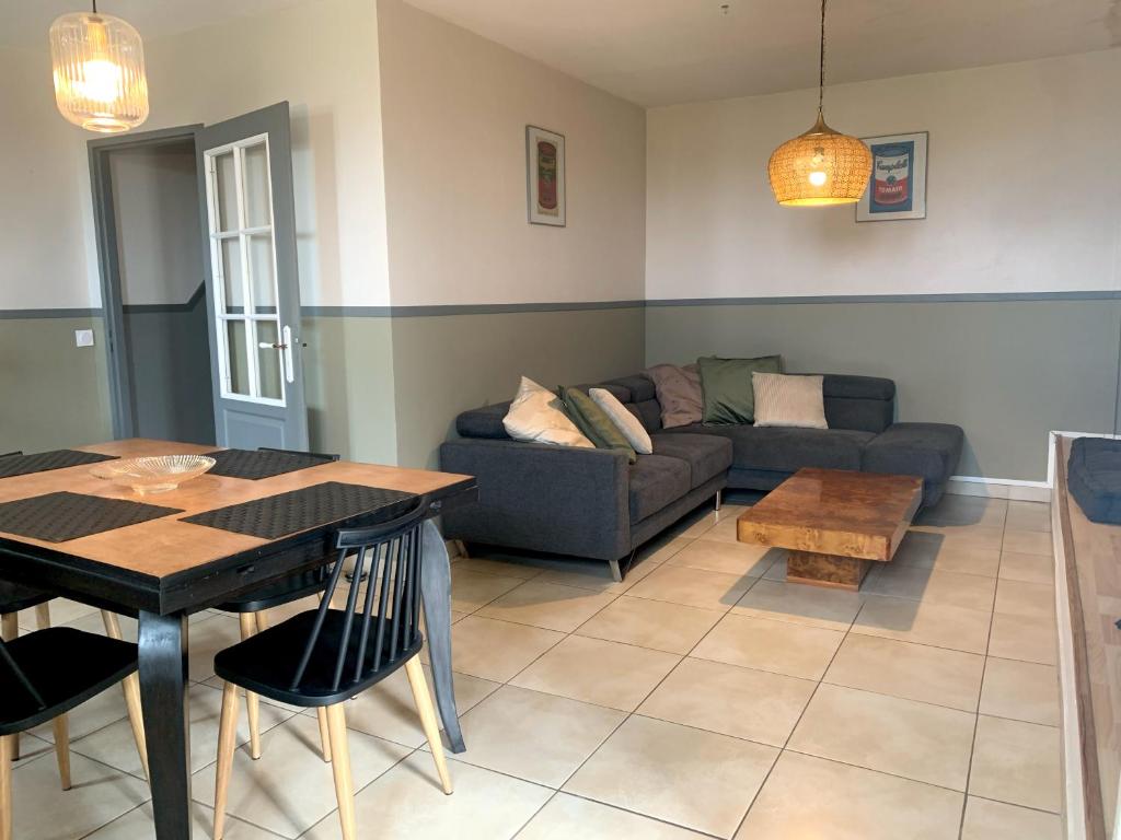 a living room with a couch and a table at La Jeannette Gîte de Charme in Chabeuil