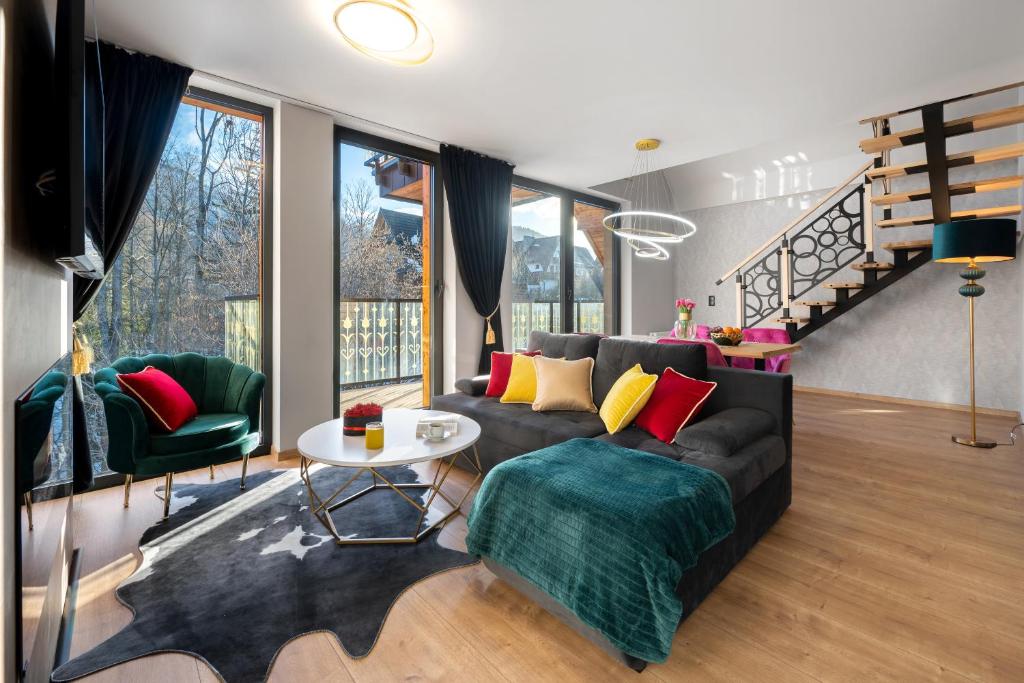 a living room with a couch and a table at Rezydencja Strążyska in Zakopane