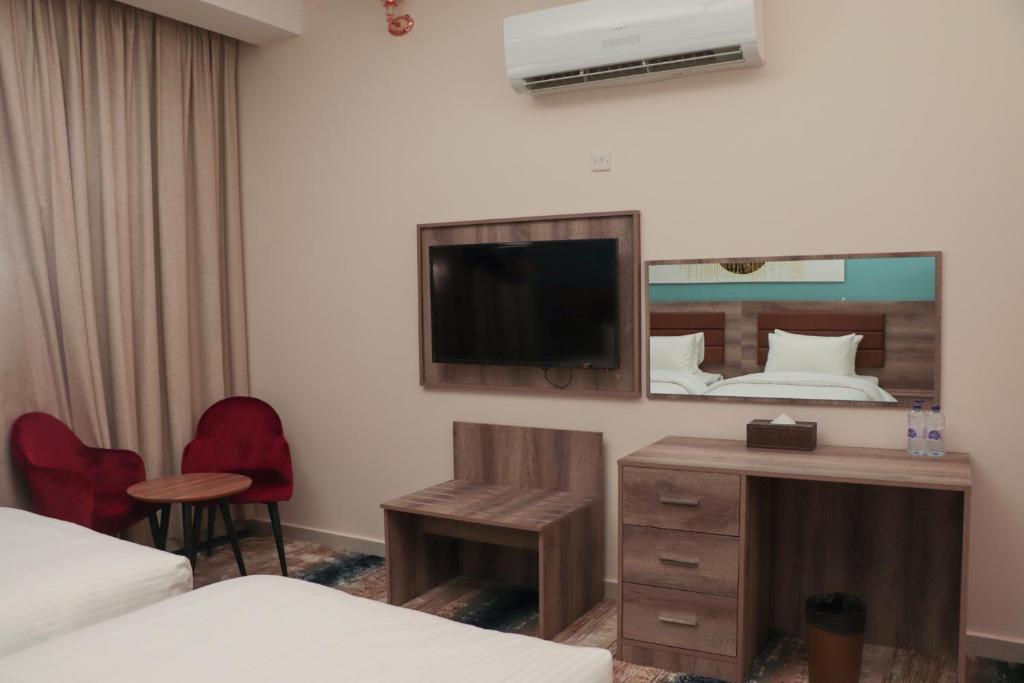 TV a/nebo společenská místnost v ubytování Ewann Hotel Apartments