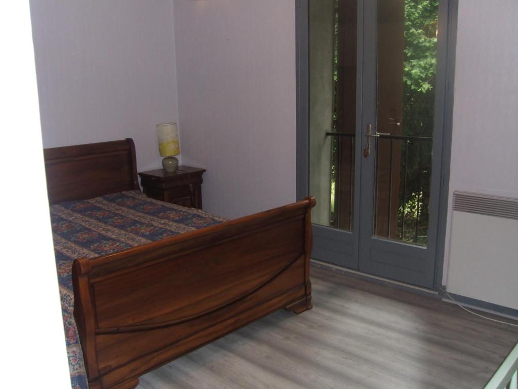 a bedroom with a bed and a sliding glass door at gite bertry 