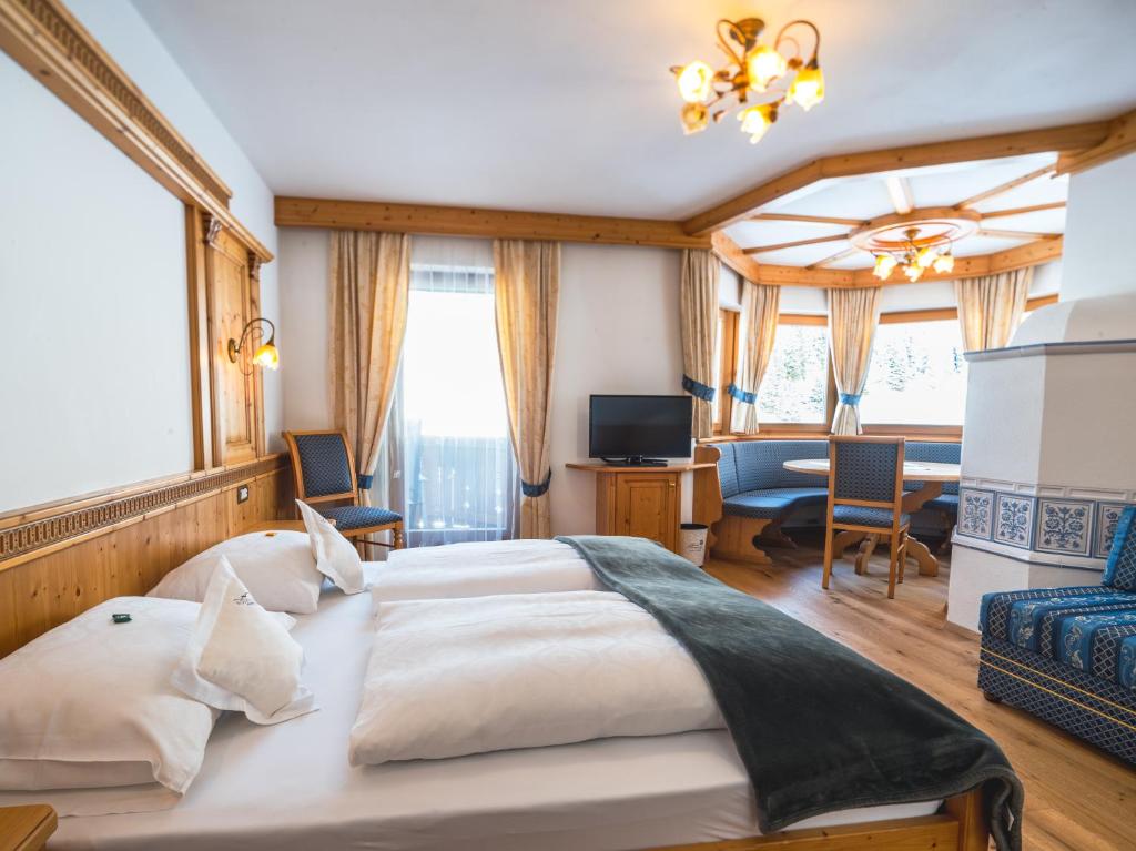 Postel nebo postele na pokoji v ubytování Garni Hotel Rosengarten B&B