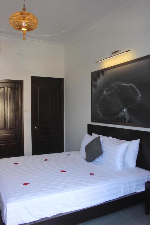 Postel nebo postele na pokoji v ubytování Hoi An Viet House Homestay