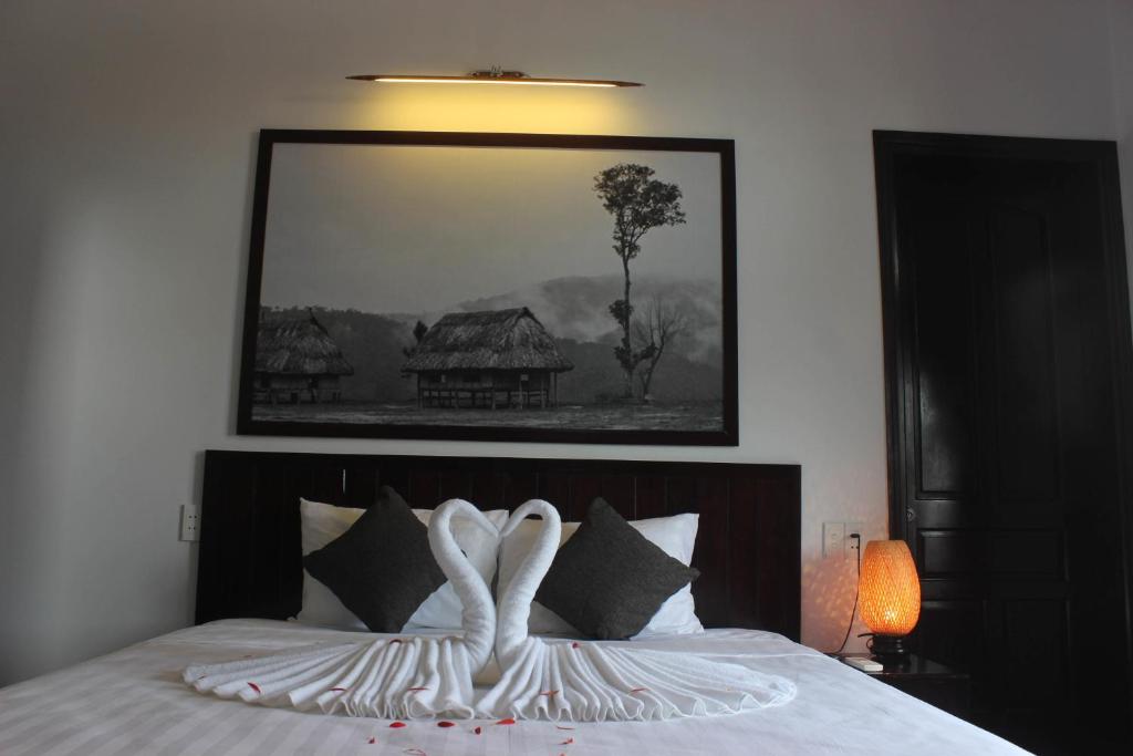 Postel nebo postele na pokoji v ubytování Hoi An Viet House Homestay