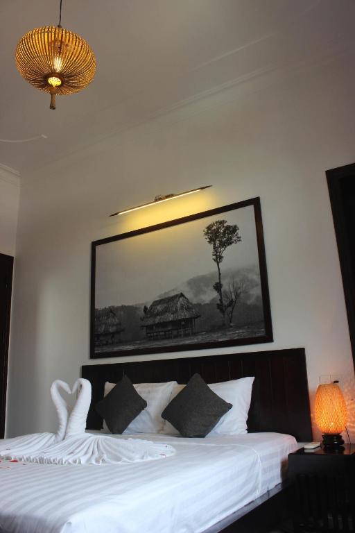 Postel nebo postele na pokoji v ubytování Hoi An Viet House Homestay