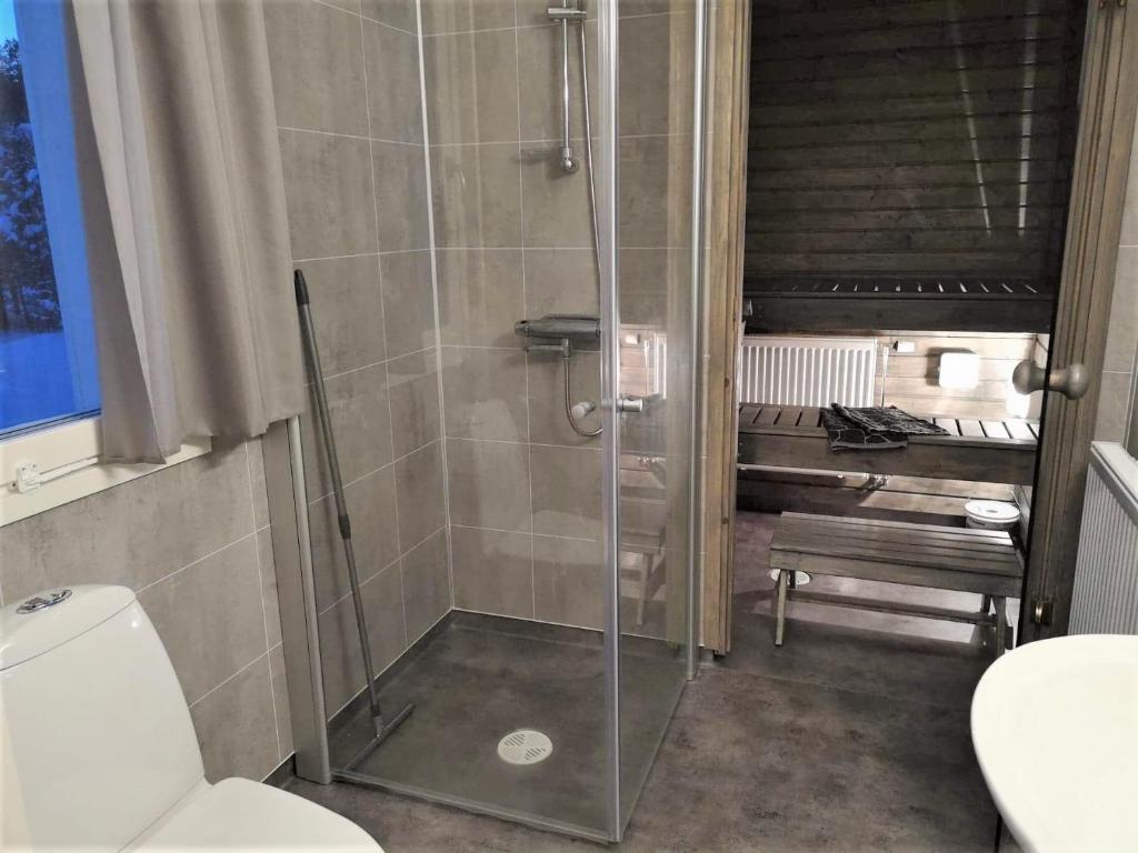 a shower stall in a bathroom with a toilet at Ailo in Inari