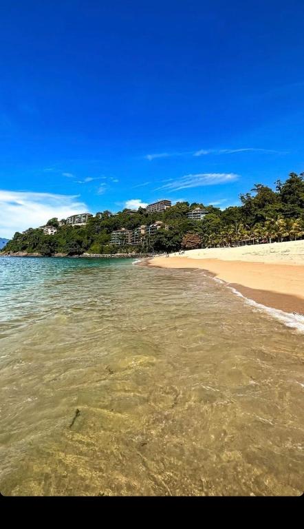 a view of a beach with the sand and water at Angra Super Luxo in Mangaratiba
