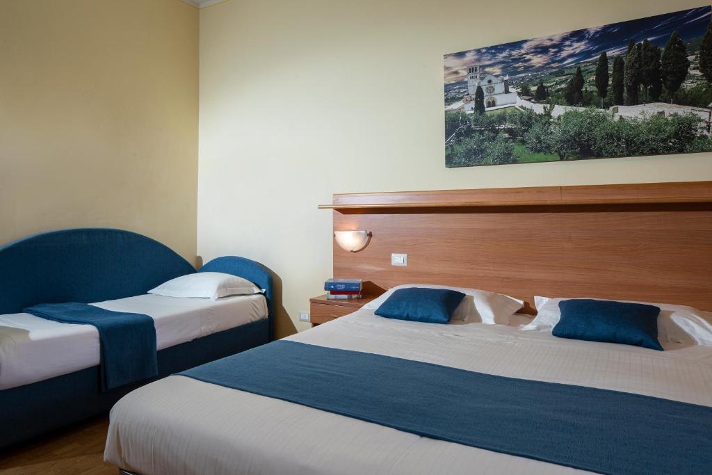 Posteľ alebo postele v izbe v ubytovaní Hotel Sacro Cuore
