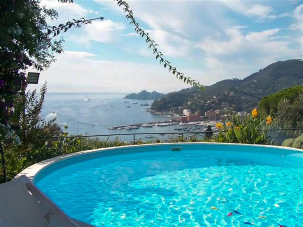 a swimming pool with a view of the ocean at L'uliveto di Santa con piscina in Santa Margherita Ligure