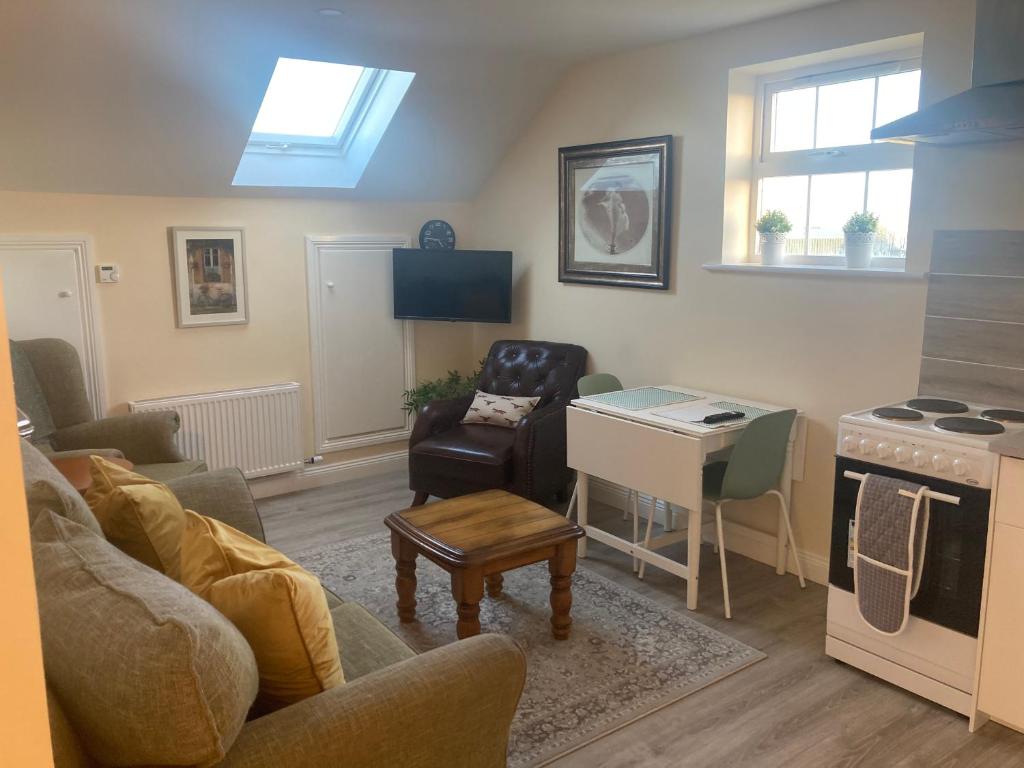 a living room with a couch and a table at Alma’s retreat in Drogheda