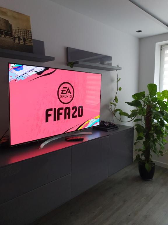 Televízia a/alebo spoločenská miestnosť v ubytovaní Galaxy Apartments