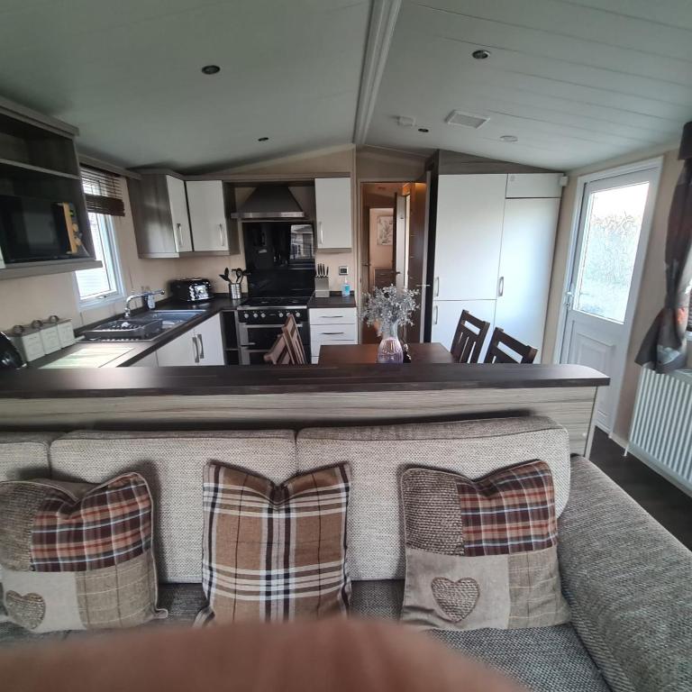 a kitchen with a counter top and a kitchen with a counter top at Oscars caravan in Abergele