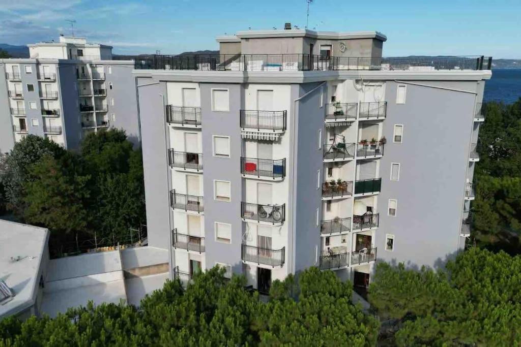 un edificio de apartamentos con balcones en la parte superior en Appartamento Luxury vista mare per 6 persone a Marina Julia, en Marina Julia