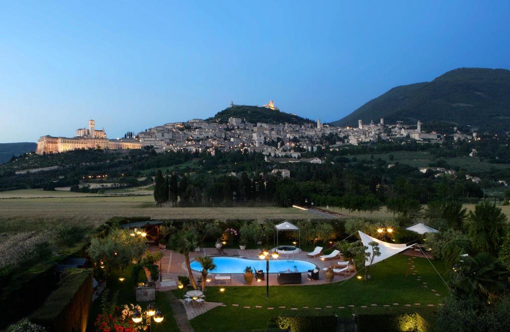 an aerial view of a resort with a town on a hill at UNICA Assisi agri-charming house in Assisi