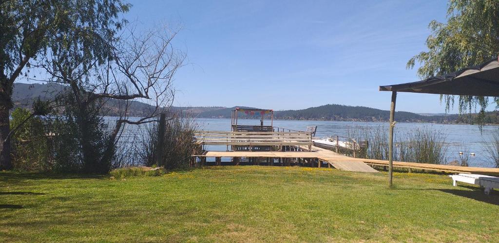 a dock on a body of water with a view at Maravillosa cabaña en orilla de Lago Vichuquén in El Rodeo