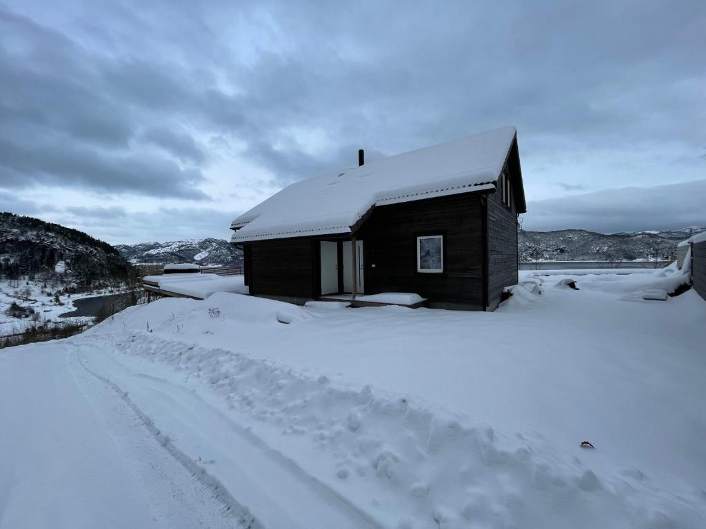 a small cabin in the snow with a snow covered road at Lakes and mountain, we got both! in Moi
