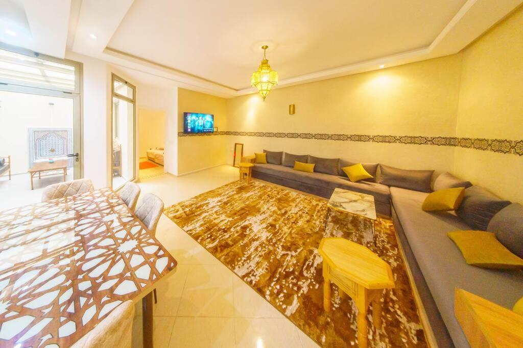 a living room with a couch and a table at Appartement tout confort in Essaouira
