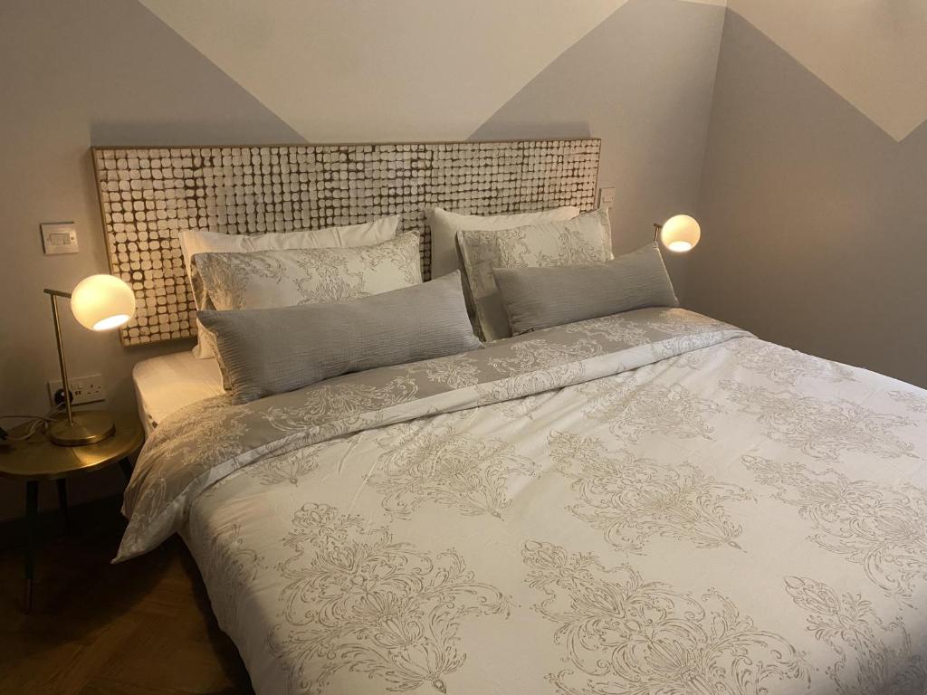 a bedroom with a large white bed with pillows at Urban Pod Hotel Liverpool in Liverpool