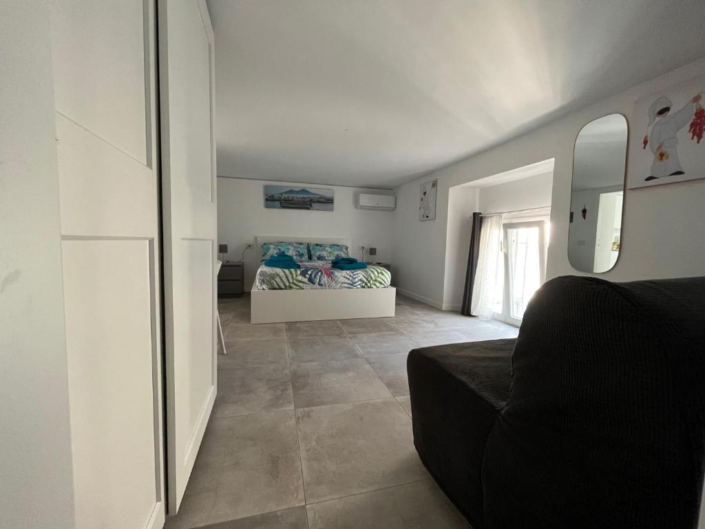 a living room with a bed and a mirror at Lucullo's Rooftop in Naples