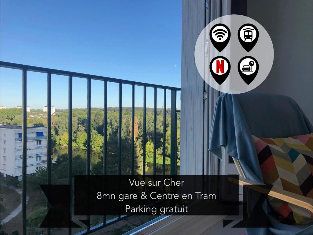 a room with a balcony with a view of a city at T2 lumineux vue sur Cher, 8mn Gare & centre in Tours