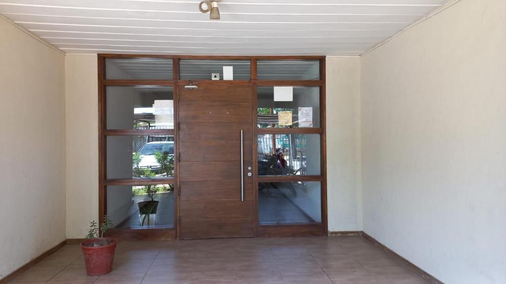 a large wooden door in a room at Departamento Tierras del Malbec in San Rafael
