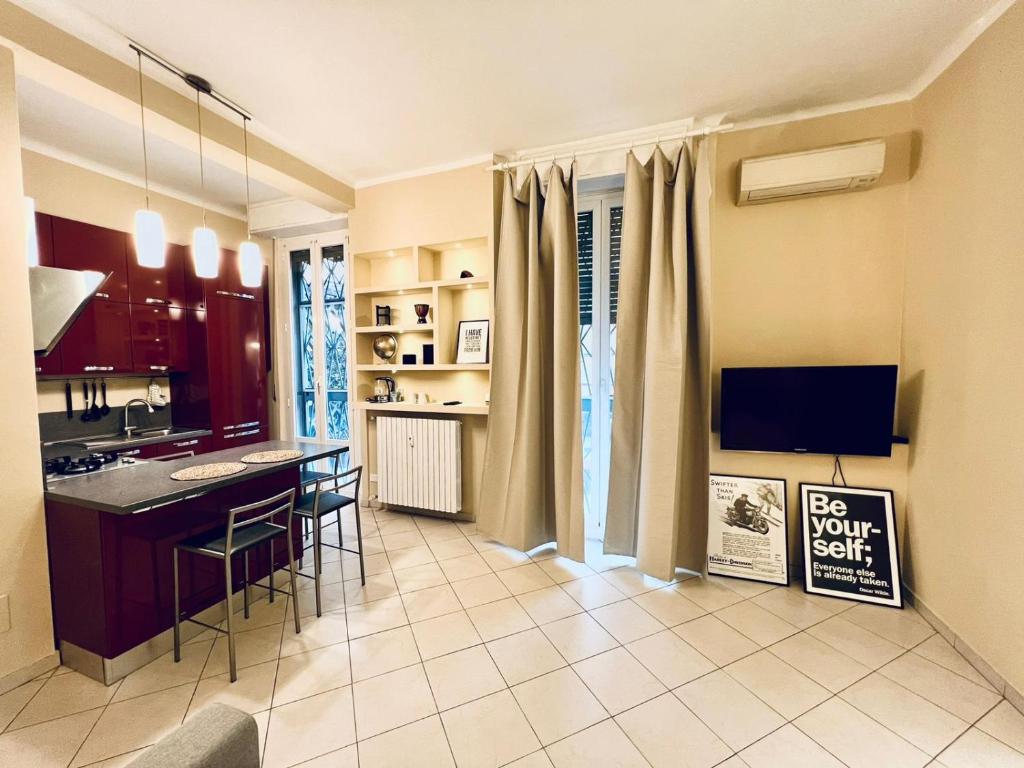 a kitchen with a table and chairs in a room at Terrazza Porta Venezia HOWME in Milan