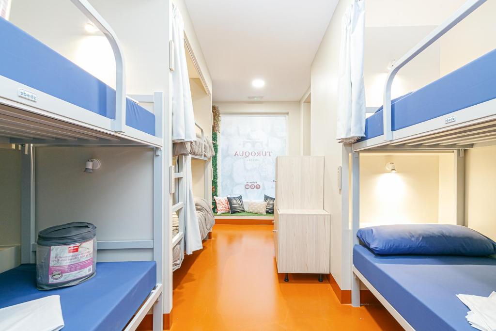 a room with two bunk beds and a hallway at Turoqua Hostel in Pontevedra