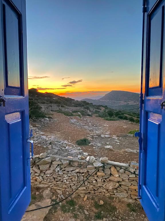 an open door with a view of a mountain at Cycladic Villa in Amorgos Island (Maison Shiro) in Arkesíni