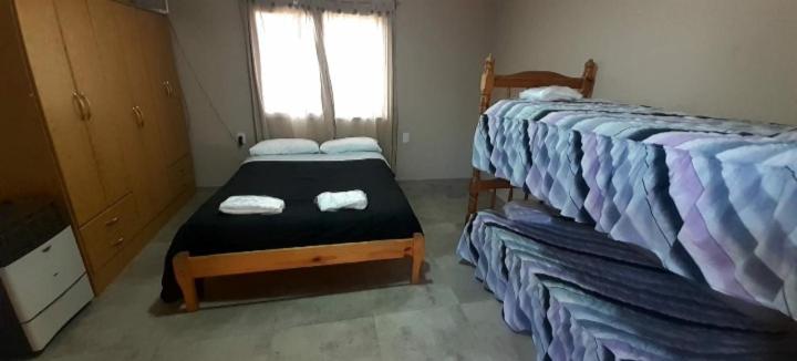 1 dormitorio con 2 camas individuales y ventana en AMOR & MIEL en General Alvear