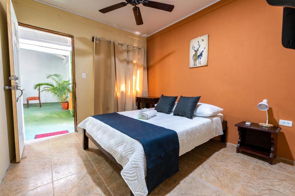 1 dormitorio con 1 cama y puerta corredera de cristal en El Cocobolo Food&Rest Room 6 Bed and Breakfast WiFi AC Pkg gratis, en Liberia