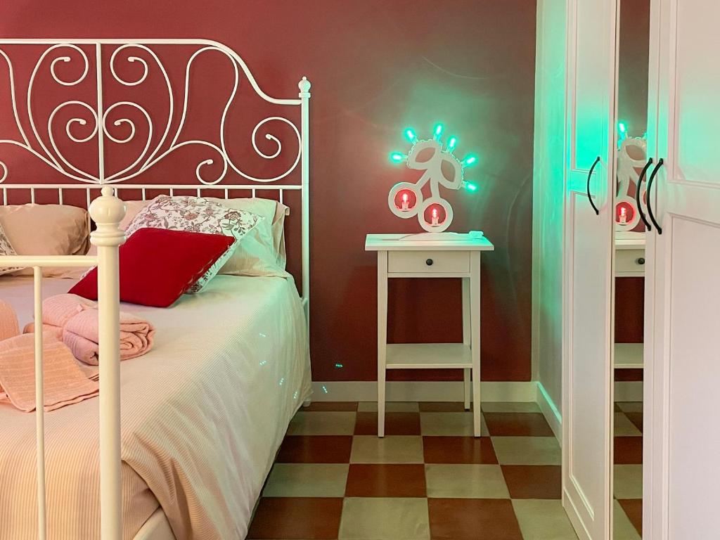 a bedroom with a bed and a table with lights at Poggio della Guardia - Montegrosso Rooms in Montegrosso