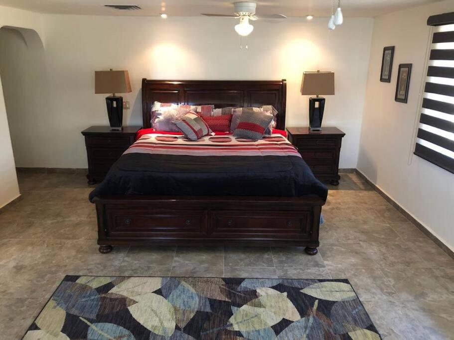 a bedroom with a large bed with two night stands at Amplia casa en Colonia Campestre in Cananea