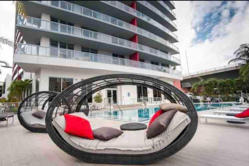 a large swing bed in front of a building at Modern apartment A - Beach Walk Resort in Hallandale Beach
