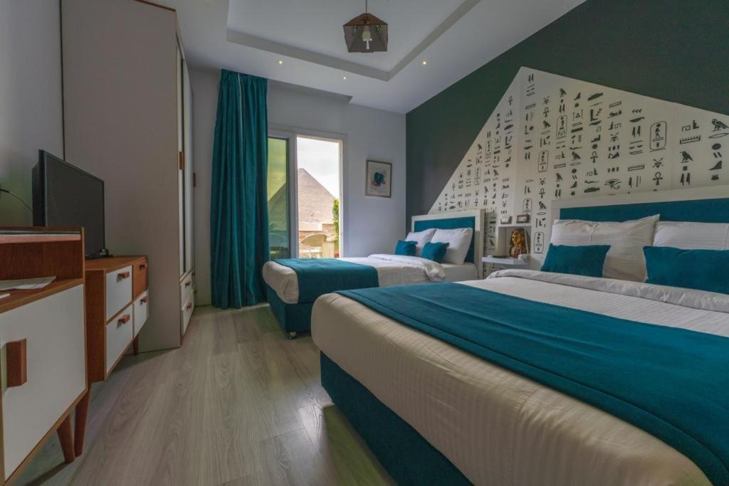 Postel nebo postele na pokoji v ubytování Elite Pyramids Boutique Hotel