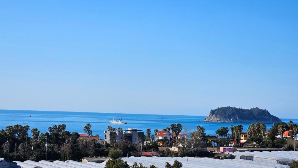 a view of a city and the ocean at Beewool Chaewool Pension in Seogwipo